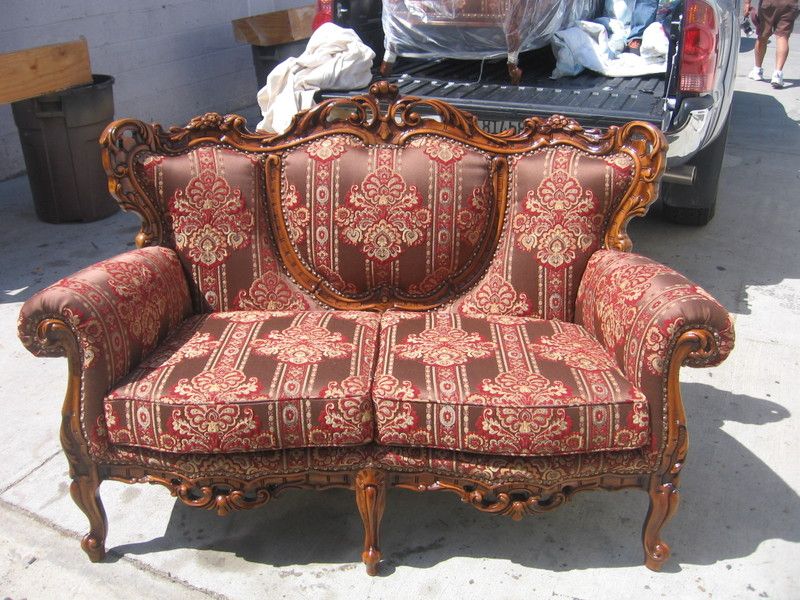 Carved wood loveseat reupholstered in red brocade