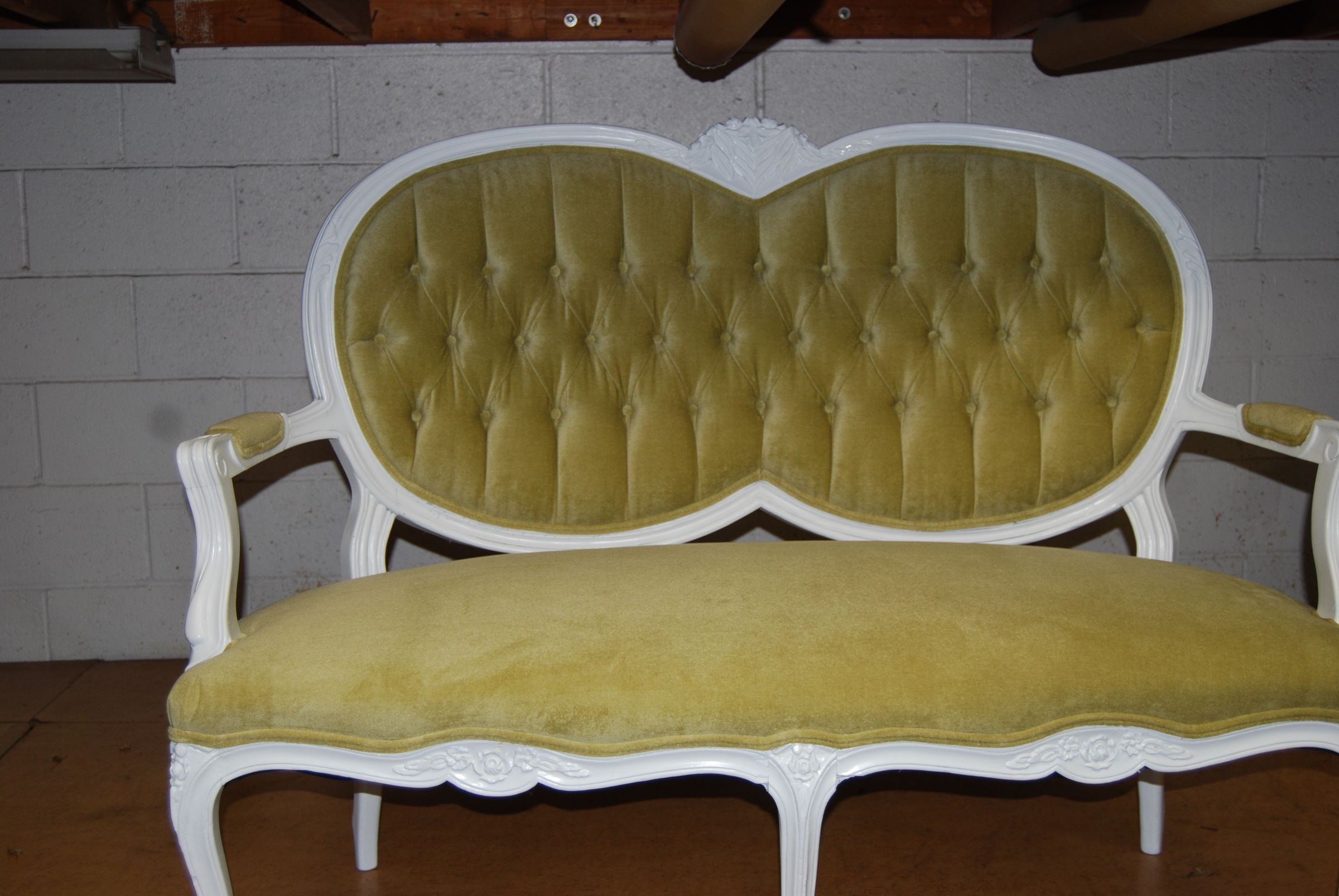 White-frame settee reupholstered in green velvet