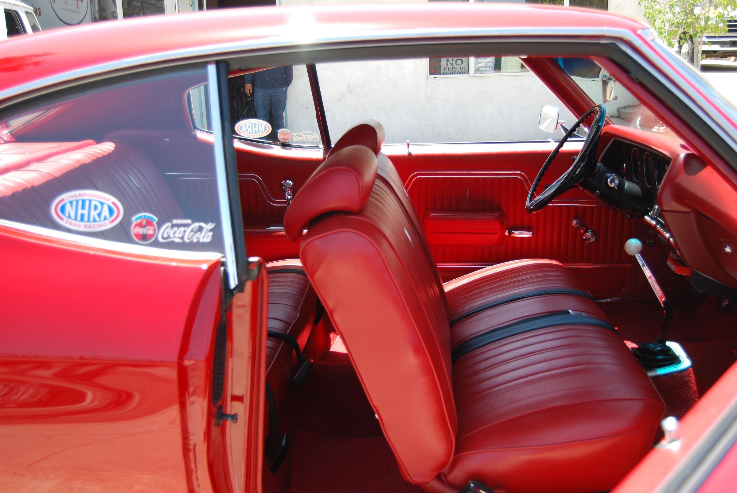 Red classic car interior with reupholstered bucket seats and door panels